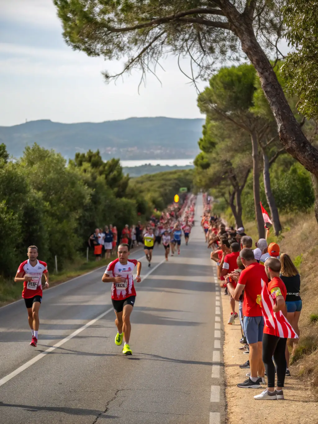 Participants of all ages running in a local marathon event, wearing ESS branded shirts, promoting community engagement and healthy lifestyles.